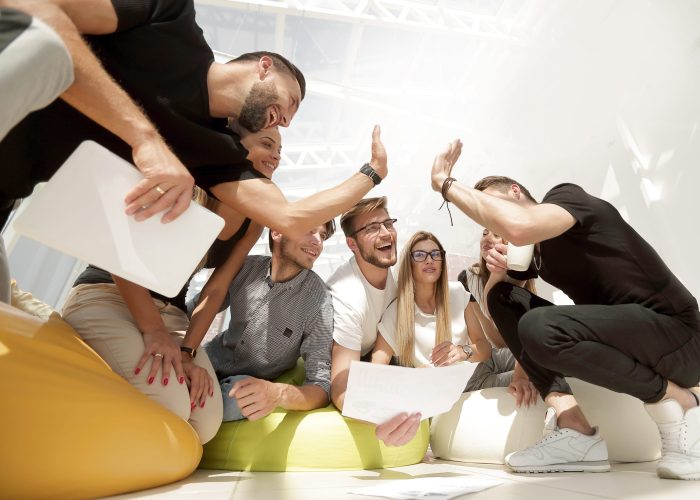 team of young people giving a high five. photo with copy space
